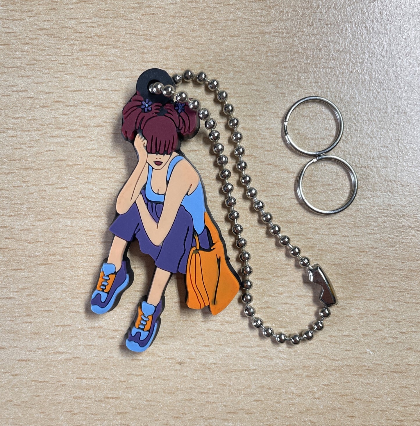 Keychain Charm girl with reddish-brown hair sitting