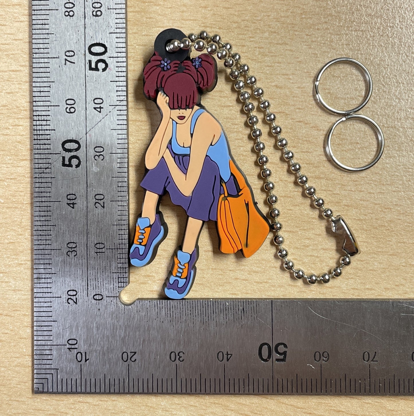 Keychain Charm girl with reddish-brown hair sitting