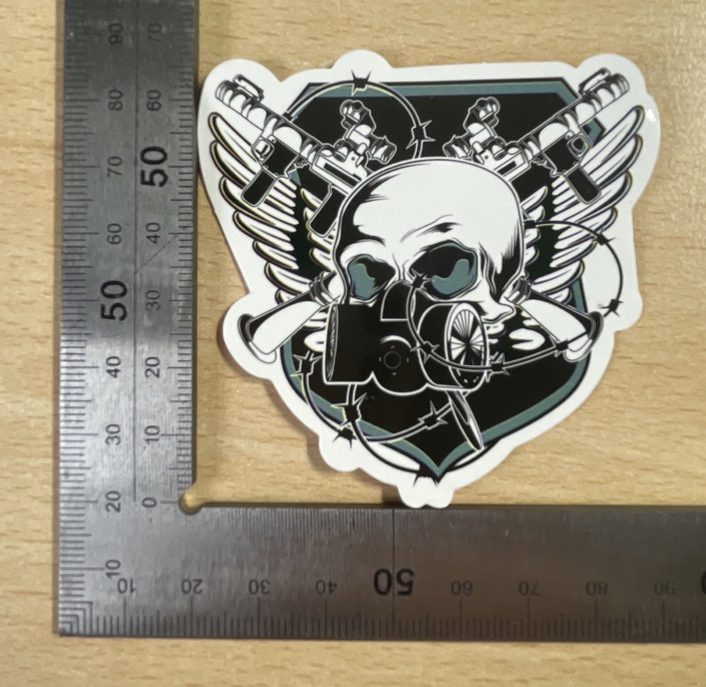 Skull wearing a gas mask on a shield Sticker
